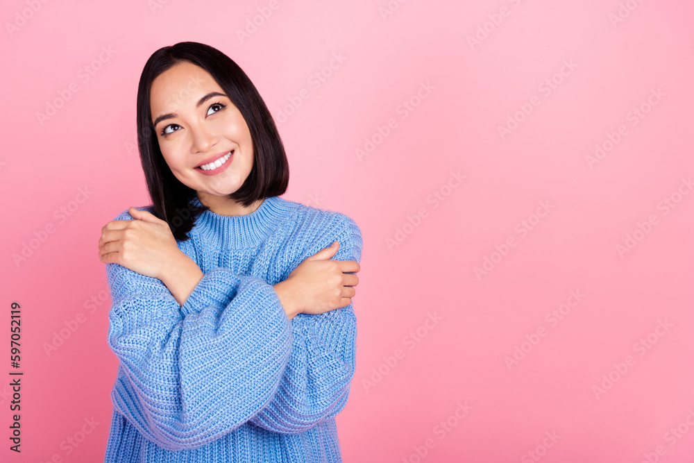 Photo of cute positive girl toothy smile hands hug shoulders look empty space isolated on pink color background Photo of cute positive girl toothy smile hands hug shoulders look empty space isolated on pink color background