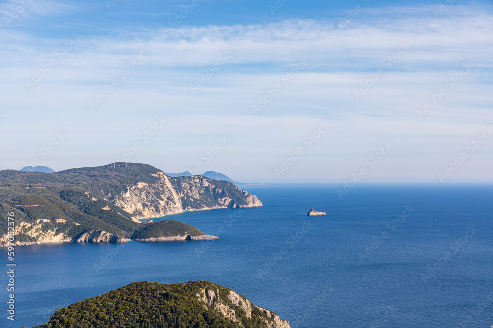 A beautiful landscape of the coast of the island of Corfu in the Ionian Sea of the Mediterranean in Greece. Pure blue clear water washes over the shores of the Greek island. A beautiful landscape of the coast of the island of Corfu in the Ionian Sea of the Mediterranean in Greece. Pure blue clear water washes over the shores of the Greek island.