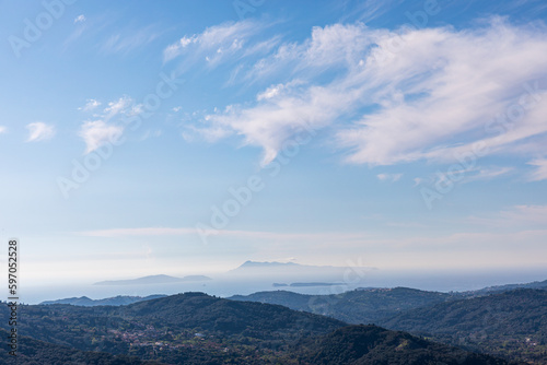 A beautiful landscape of the island of Corfu in the Ionian Sea in Greece. Mountains with plenty of green vegetation. Thick clouds over the island. 