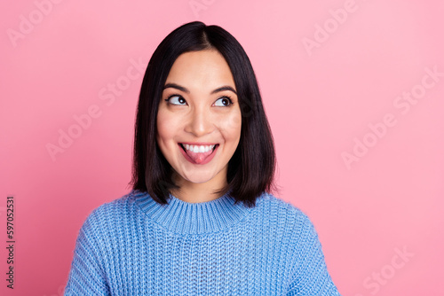 Portrait of nice cheerful lady toothy smile stick out tongue look empty space isolated on pink color background © deagreez