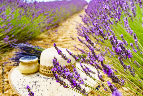 Summer hat and jar with honey at lavender field. Holidays in France.