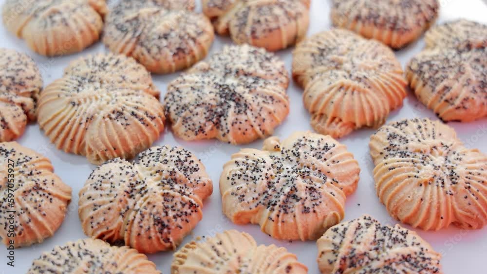 Top view of rotating poppy seed cookies on white surface. Concept of homemade cookies and goodies Top view of rotating poppy seed cookies on white surface. Concept of homemade cookies and goodies
