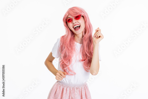 Adorable barbie girl young woman on white background in studio isolated posing for camera in different emotions wearing plain white t-shirt and pink skirt.