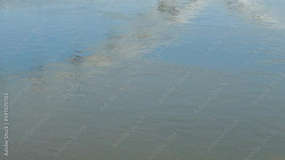 Modern bridge structure reflecting of the river water surface on sunny spring day Modern bridge structure reflecting of the river water surface on sunny spring day