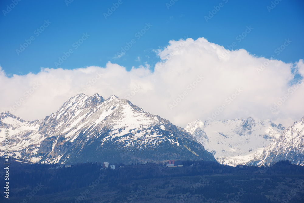 slovakia countryside in spring. snowcapped peaks beneath huge white clouds. nature background in gorgeous light