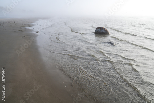 Fototapeta Naklejka Na Ścianę i Meble -  Fog on Baltic sea coastline at spring. Moody weather, mist, waves