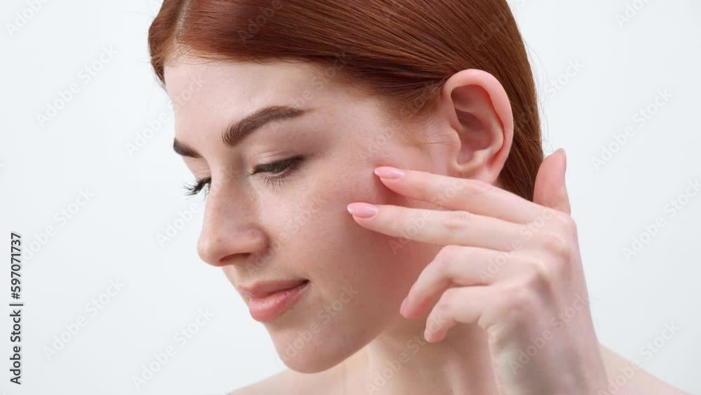 Young beautiful girl with red hair and green eyes on white background, camera tracking movements Young beautiful girl with red hair and green eyes on white background, camera tracking movements