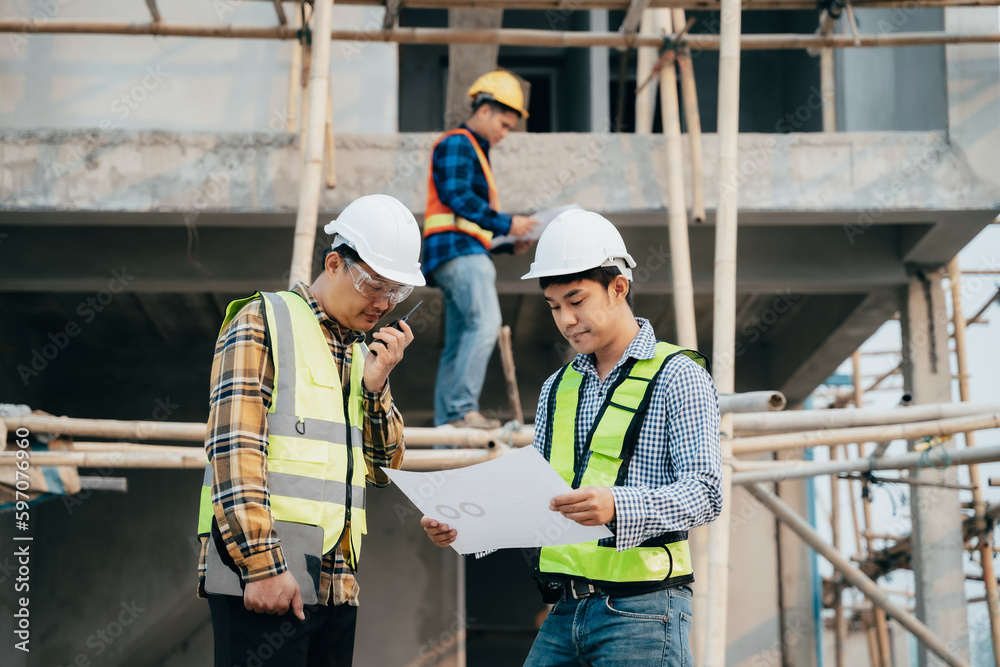 Group architect team on construction site inspection documents and business workflow in the morning. Group architect team on construction site inspection documents and business workflow in the morning.