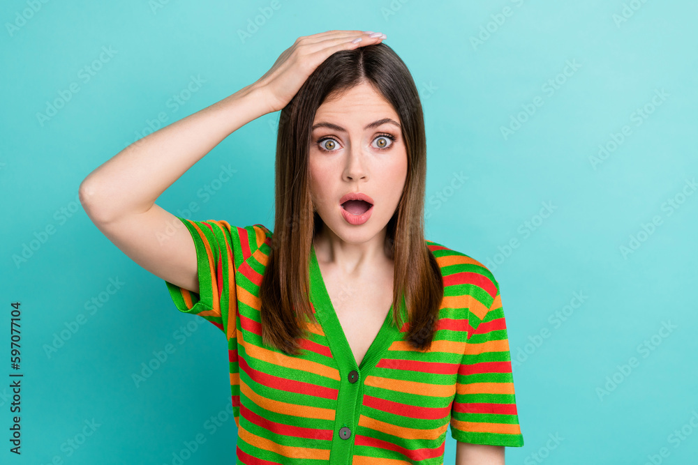 Photo of cute impressed woman dressed striped cardigan arm head open mouth isolated teal color background Photo of cute impressed woman dressed striped cardigan arm head open mouth isolated teal color background