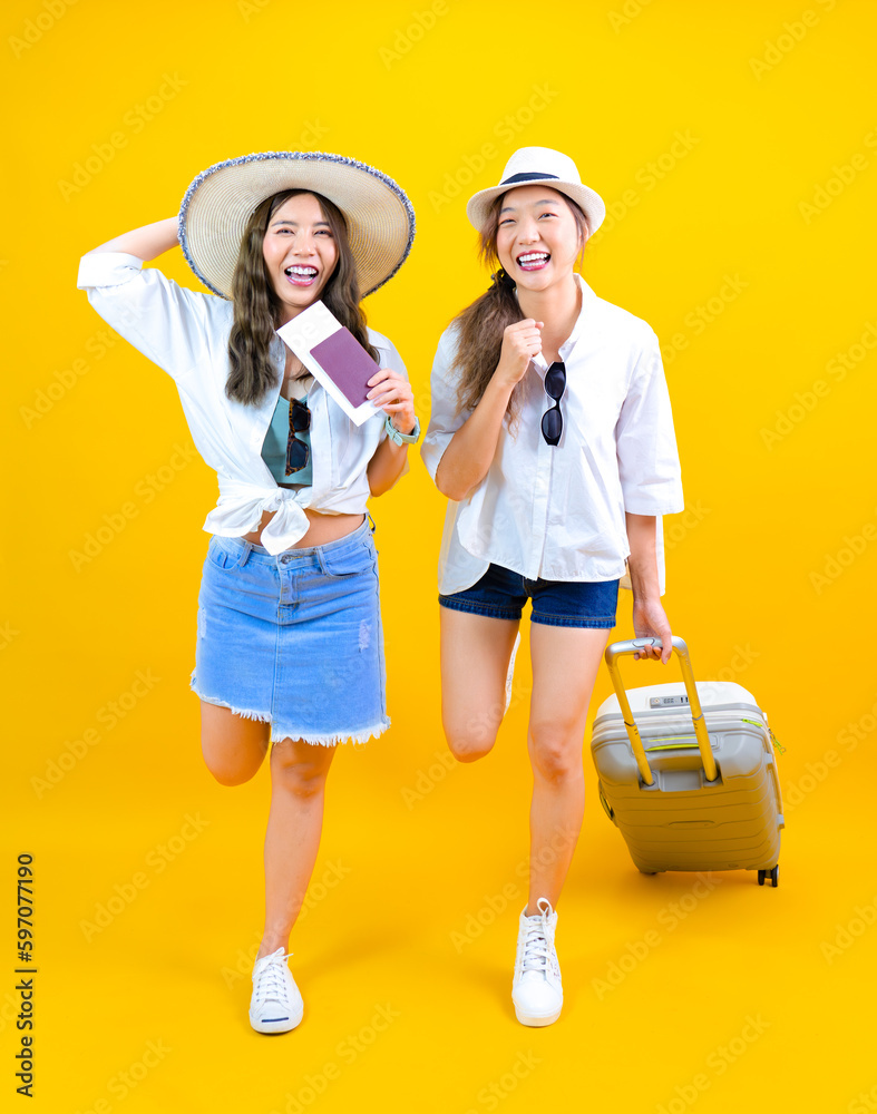 young Asian pretty woman friends traveling abroad smiling and looking at camera isolated on yellow studio background, cheerful passenger running with valise suitcase during summer vacation young Asian pretty woman friends traveling abroad smiling and looking at camera isolated on yellow studio background, cheerful passenger running with valise suitcase during summer vacation
