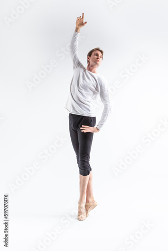 Full Length Portrait of Caucasian Young, Handsome Sporty Athletic Ballet Dancer with Lifted Hand Over White.