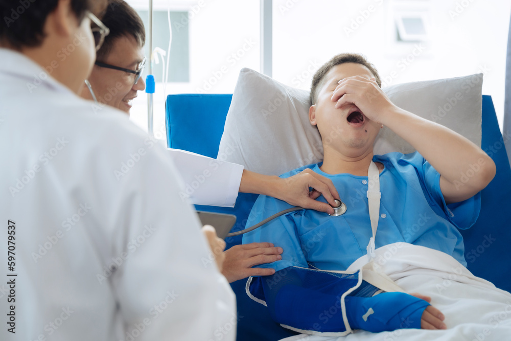 Accident, health and people concept. Doctor talking to male patient on hospital bed.