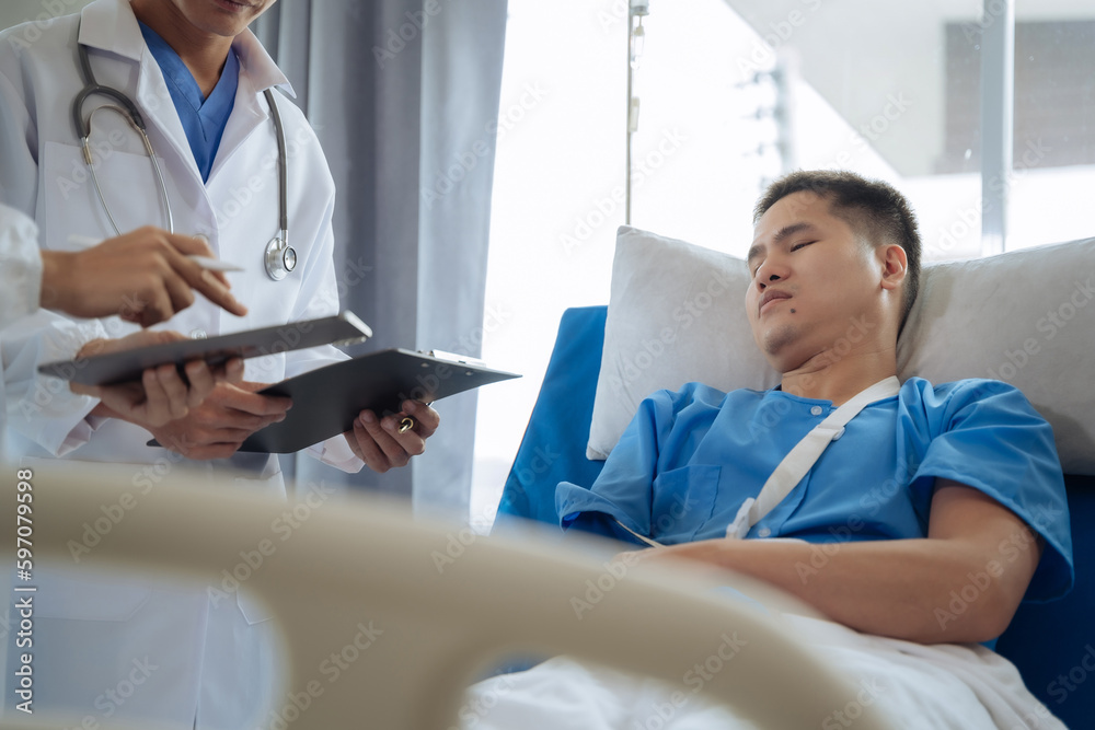 Accident, health and people concept. Doctor talking to male patient on hospital bed. Accident, health and people concept. Doctor talking to male patient on hospital bed.