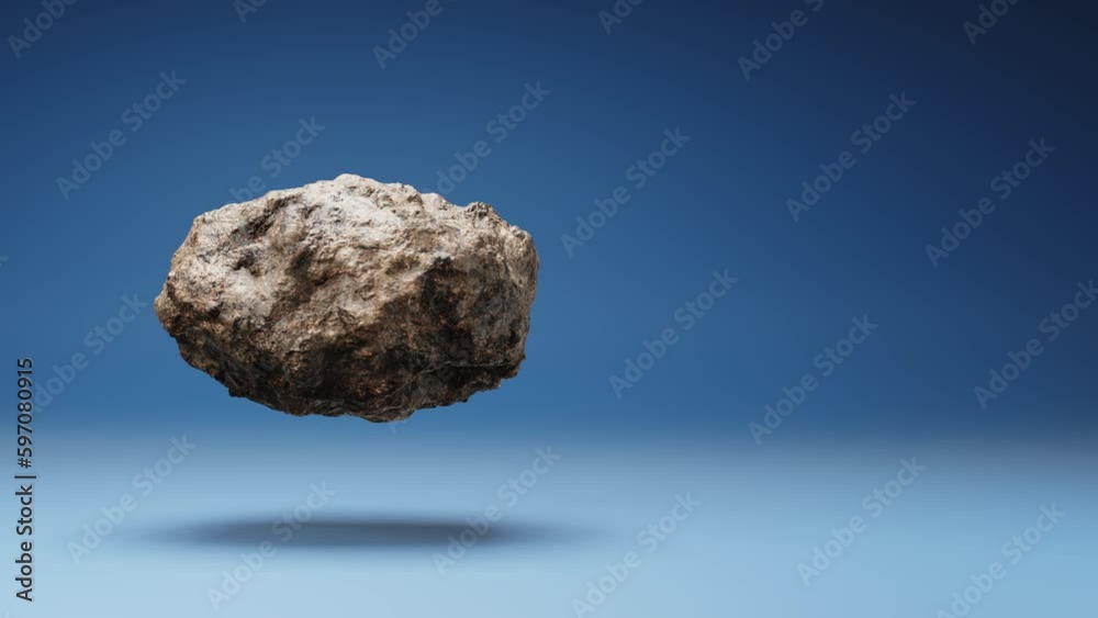 One Detailed Asteroid Spinning on a Studio Blue Background, Seamless Loop 3D Animation with Copy Space One Detailed Asteroid Spinning on a Studio Blue Background, Seamless Loop 3D Animation with Copy Space