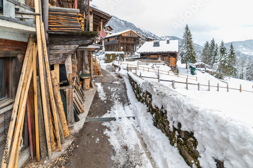 Snowfall in Sauris. Among the woods and historic houses. photo