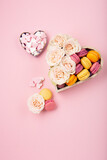 Cookies Macaroons in Gift Box, Rose Flowers and Candies on Pink Background. Holiday Presents Concept