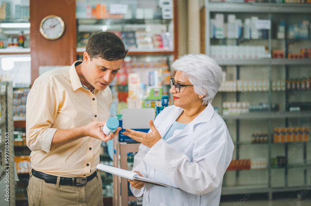 Pharmacist giving advice And advice for patients who come to buy Medicine, Drugs, Vitamins products, according to prescriptions in modern pharmacies. Pharmacist giving advice And advice for patients who come to buy Medicine, Drugs, Vitamins products, according to prescriptions in modern pharmacies.
