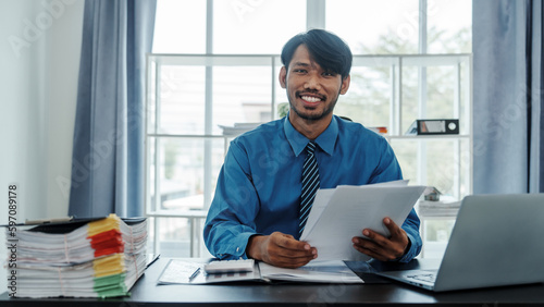 Portrait of mixed race positive successful indian asian chinese company ceo businessman freelancer or recruitment broker working in office, smiling friendly © NanSan