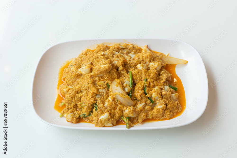 Stir fried crab meat with curry delicious seafood in a white plate. Stir fried crab meat with curry delicious seafood in a white plate.