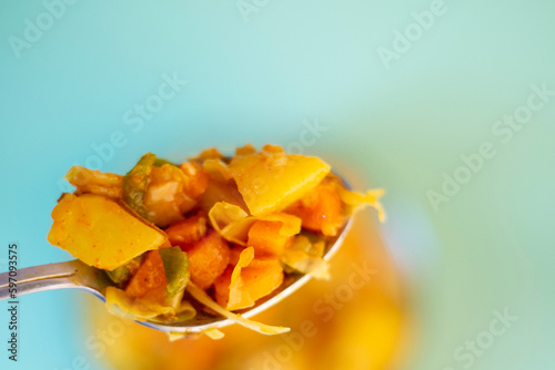 A Spoon Of Mixed Vegetables, Mix Vegetable. top View, Isolated On sky blue Background. selective focus