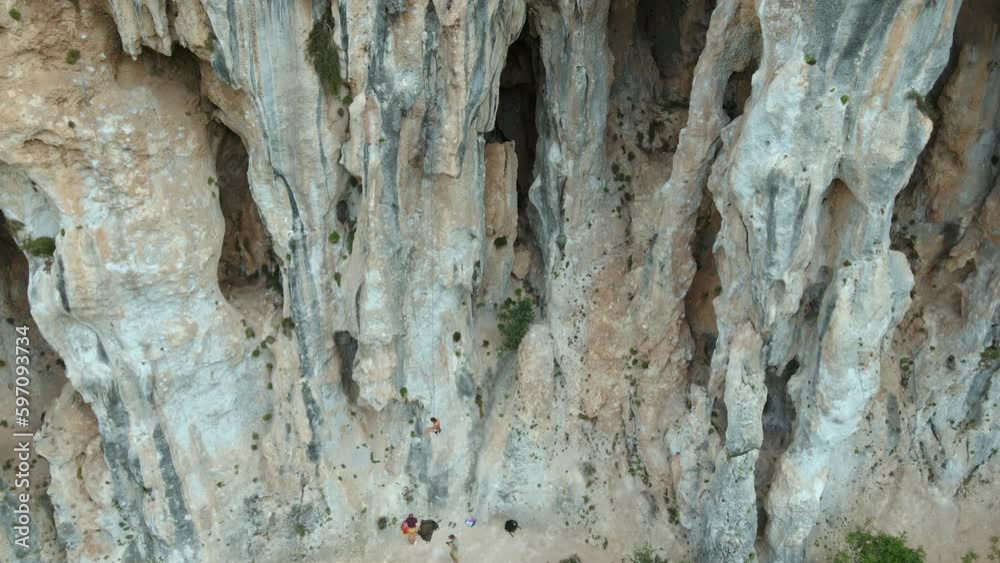 Aerial view of Young fit woman descending on ground after lead rock climbing on sport route on vertical cliff, outdoors rock climbing, cinematic slow motion rock climbing moments Aerial view of Young fit woman descending on ground after lead rock climbing on sport route on vertical cliff, outdoors rock climbing, cinematic slow motion rock climbing moments