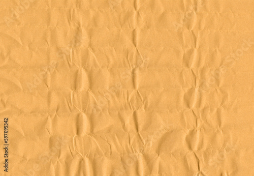 Yellow wrapping paper with dents and chaotic folds texture