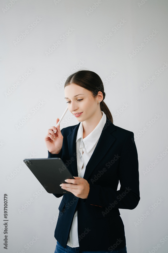 Smiling caucasian young businesswoman bank employee worker manager boss ceo looking at camera, using tablet, laptop and notepad online isolated in white background. Smiling caucasian young businesswoman bank employee worker manager boss ceo looking at camera, using tablet, laptop and notepad online isolated in white background.