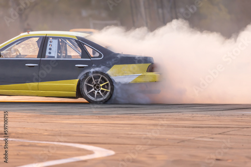 Drift car burning tires on speed track.