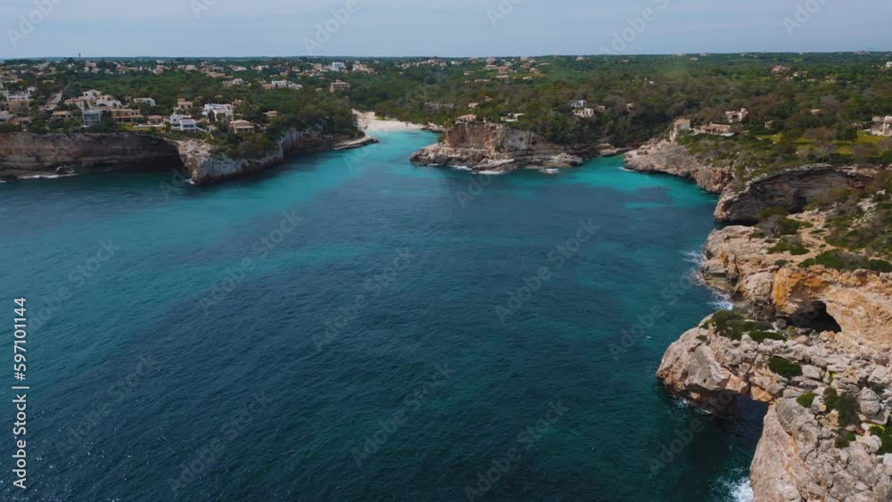 Es Pontas remote bay, clear turquoise blue sea water with white sand beach, luxury villa. Palma de Mallorca Island Spanish Balearic Majorca seaside coast. Cinematic tourist vacation. Aerial drone 4K Es Pontas remote bay, clear turquoise blue sea water with white sand beach, luxury villa. Palma de Mallorca Island Spanish Balearic Majorca seaside coast. Cinematic tourist vacation. Aerial drone 4K