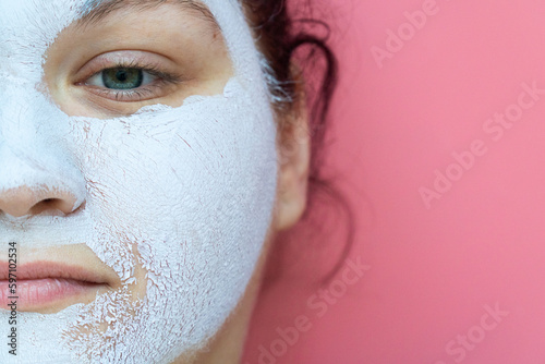 face of a beautiful young woman with a cosmetic mask