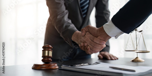 Handshake after cooperation between attorneys lawyer and clients discussing a contract agreement legal fighters  Concepts of law  advice