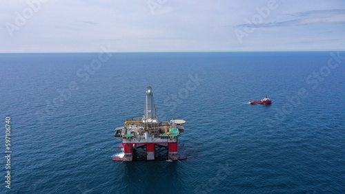 day. aerial survey, there is a semi-submersible drilling platform with the name "Polar Star" in red and white color in the sea, next to a red-colored vessel. © Евгений Г