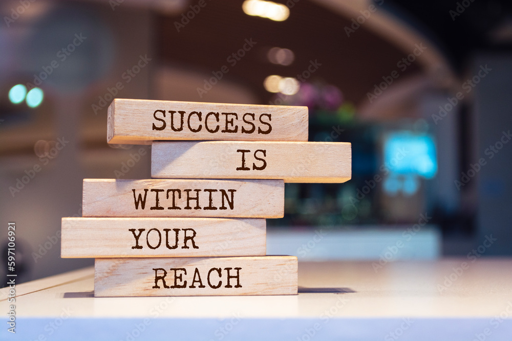 Wooden blocks with words 'Success is within your reach'. Inspirational motivational quote