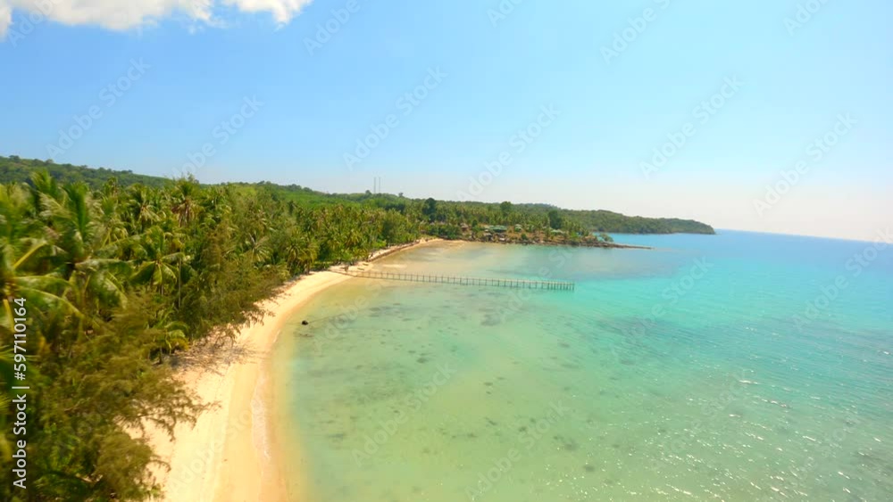 Drone flying over coconut palm trees and stunning white sand beach with turquoise water. Drone flying over coconut palm trees and stunning white sand beach with turquoise water.