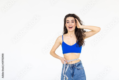 Young woman measuring her waist isolated on a white background