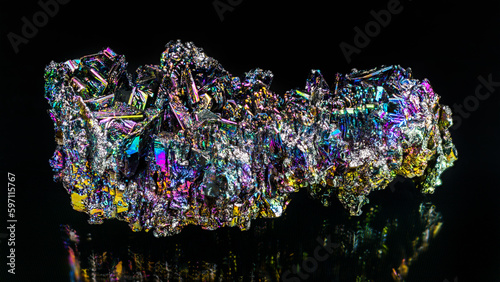 Beautiful colored silicon carbide mineral crystals with reflection on black background. Synthetic carborundum chemical compound. Use as abrasive, semiconductor or diamond gem simulant. Raw moissanite. photo