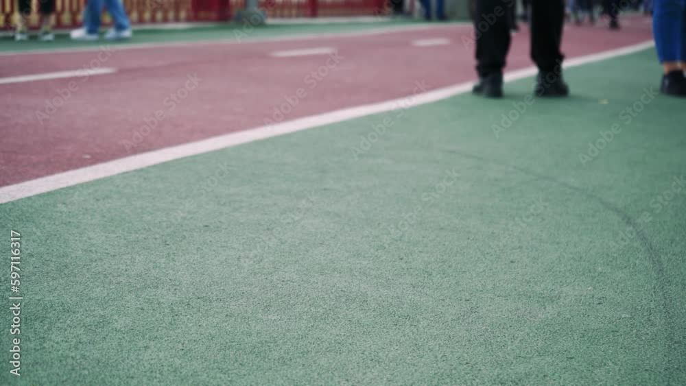 A red cycle path where people walk. Bicycle path for cycling. Feet walking on the track close-up. background video. A red cycle path where people walk. Bicycle path for cycling. Feet walking on the track close-up. background video.