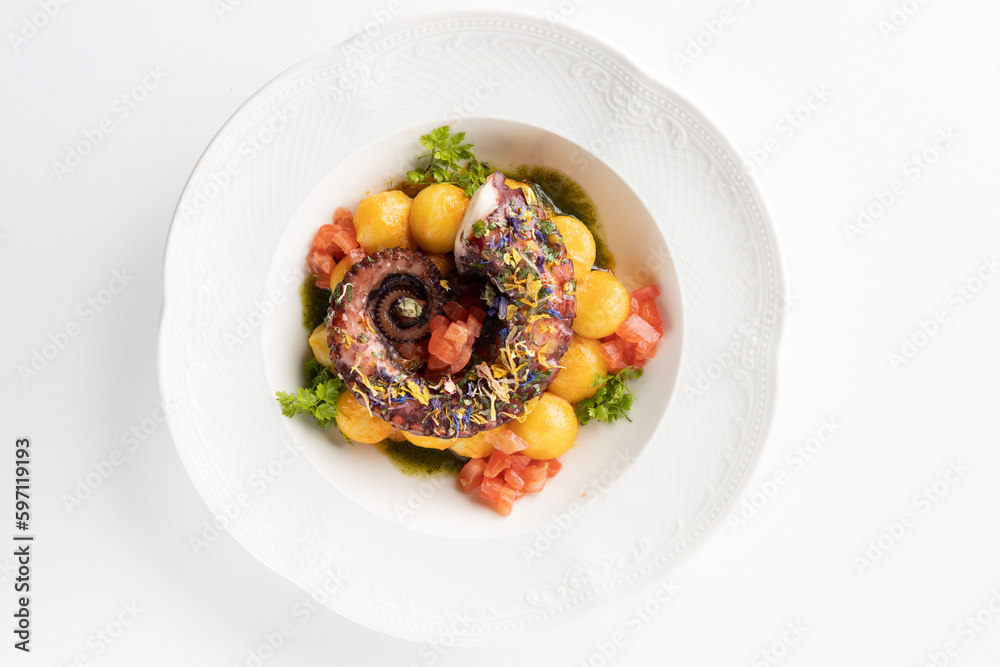 octopus with boiled potatoes and vegetables on a white background octopus with boiled potatoes and vegetables on a white background