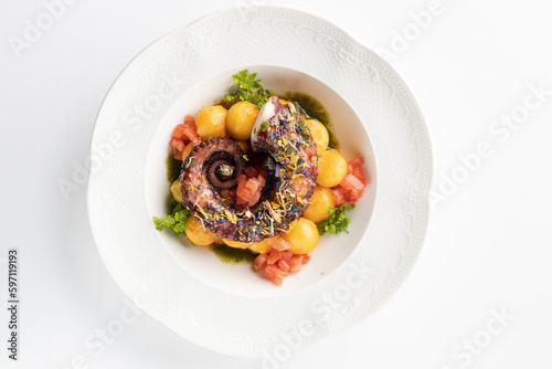 octopus with boiled potatoes and vegetables on a white background