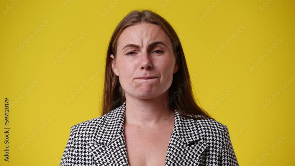 4k video of one woman feeling bad over yellow background. 4k video of one woman feeling bad over yellow background.