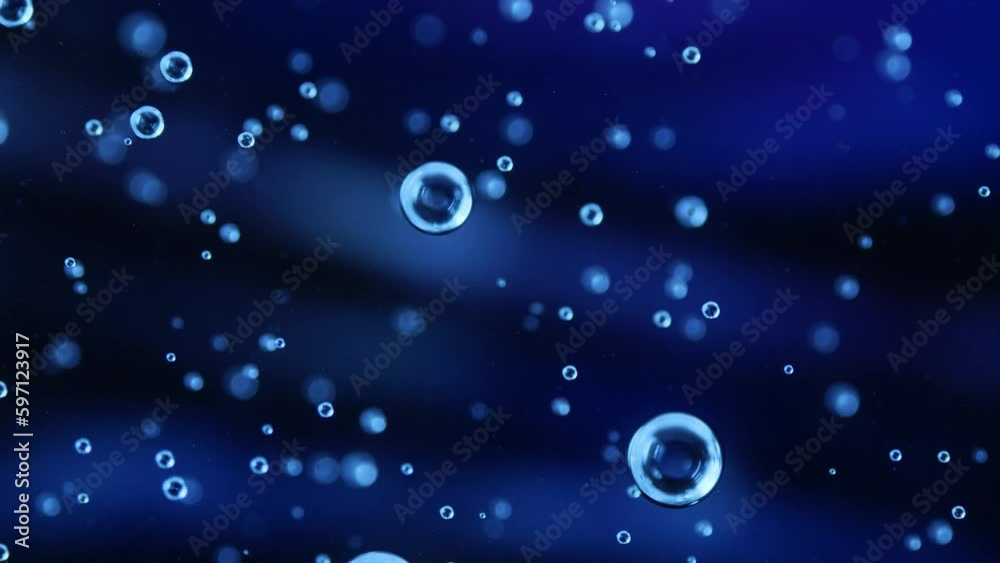 Liquid texture with drops on dark blue background. Gel cosmetic with molecule bubbles. Macro shot of air bubbles. Skincare gel ingredients and water for its commercial. Liquid texture with drops on dark blue background. Gel cosmetic with molecule bubbles. Macro shot of air bubbles. Skincare gel ingredients and water for its commercial.