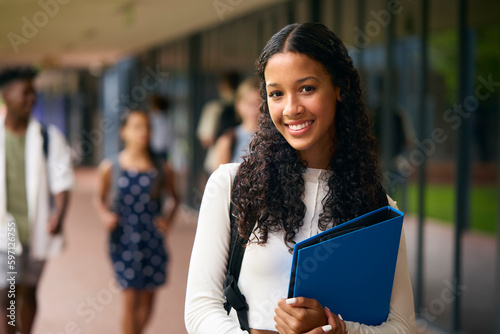 Portrait Of Female Secondary Or High School Student Outdoors At School Walking To Class photo