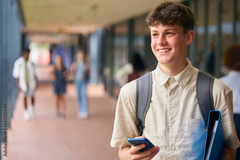 Portrait Of Male Secondary Or High School Student Outdoors At School With Mobile Phone Portrait Of Male Secondary Or High School Student Outdoors At School With Mobile Phone