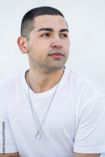 Close up portrait of a young beautiful brunette guy © Andrey_Arkusha