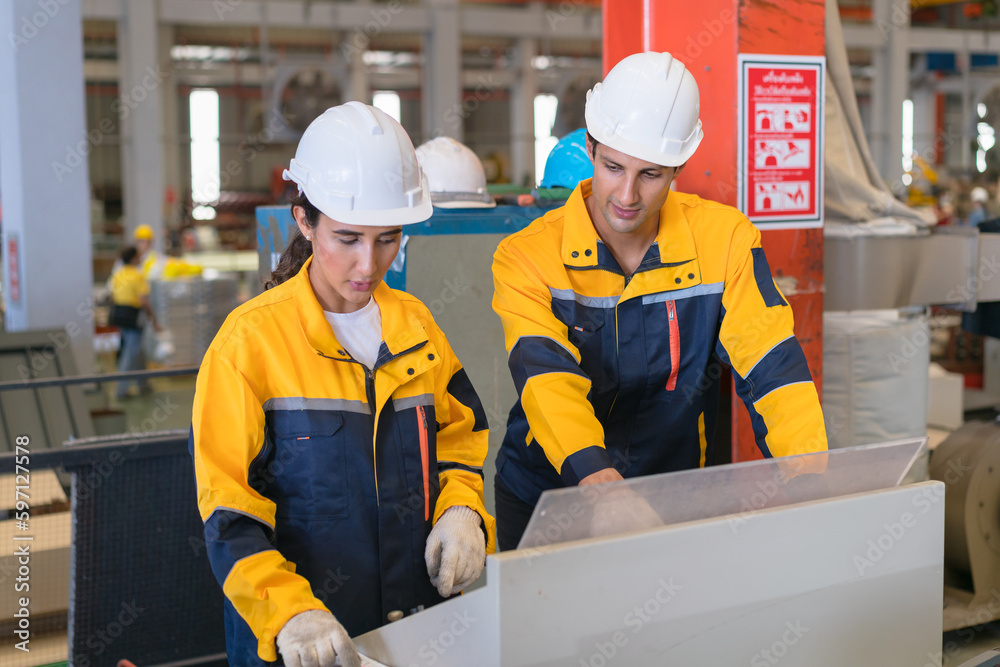 Professional heavy industry engineer worker wearing safety uniform in a metal manufacture warehouse , maintenance service check for safety first concept . Professional heavy industry engineer worker wearing safety uniform in a metal manufacture warehouse , maintenance service check for safety first concept .