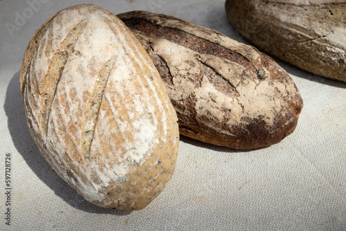 Baked bread of sourdough. Artisan bread on light background. The bread of sourdough, homemade and natural creation. 