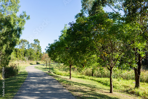 Walking path through reserve in Singleton with native king parrot birds in trees photo