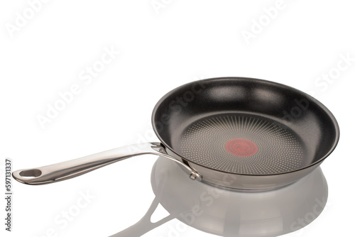 One metal frying pan, macro, isolated on white background.