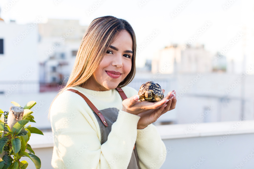 pretty latin woman with a tortoise pet pretty latin woman with a tortoise pet