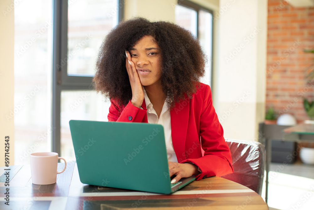 pretty afro black woman feeling bored, frustrated and sleepy after a tiresome. businesswoman and laptop concept pretty afro black woman feeling bored, frustrated and sleepy after a tiresome. businesswoman and laptop concept
